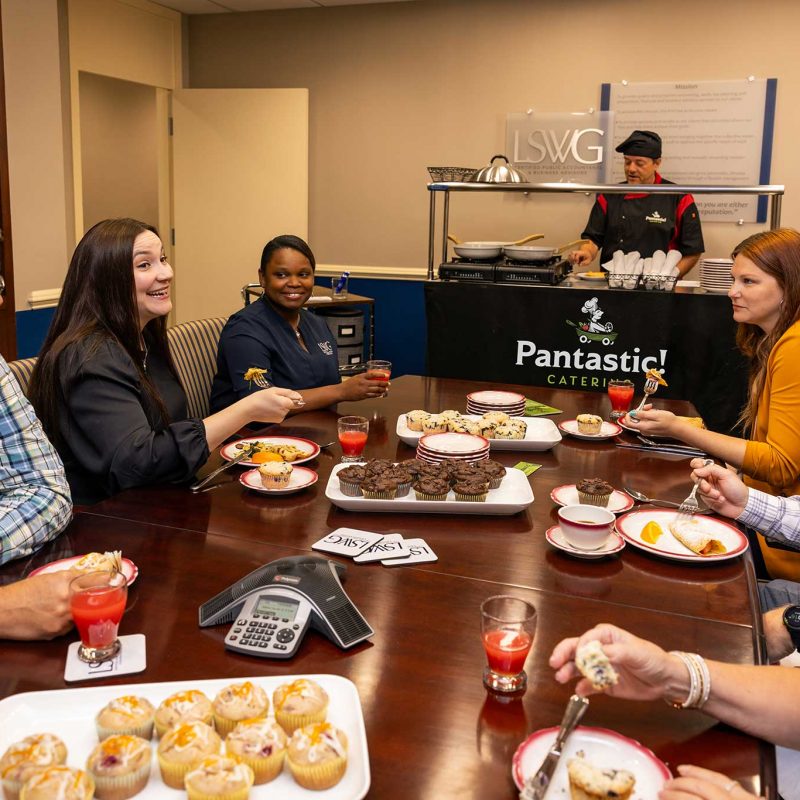 Chef David Sneed interacting with guests while preparing fresh meals at their office location.